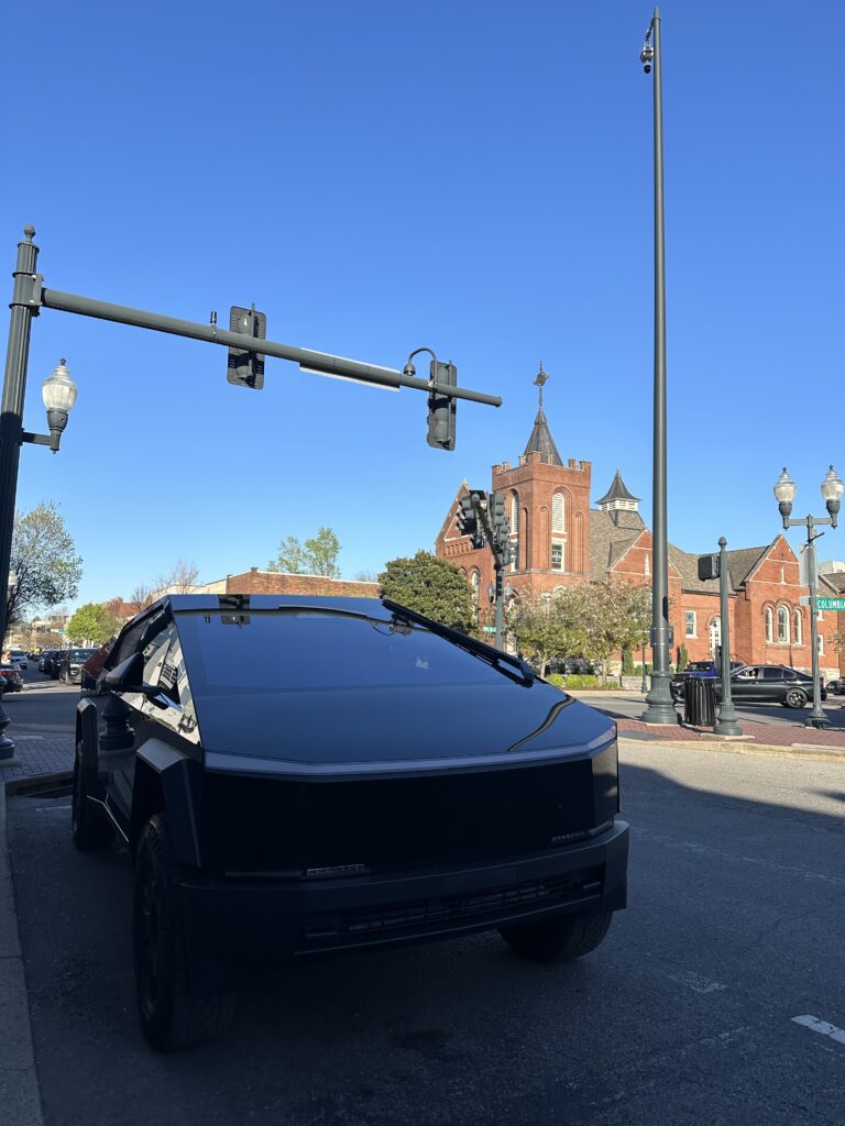 historic Franklin juxtaposed with a Tesla truck